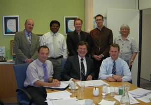 Picture shows Chris Bustin (seated left) signing a Memorandum of Understanding on behalf of the European Union with Richard Hopkins (seated centre) representing the Australian partners.  Other members of the project team are also present.