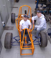 pics show Gareth and Mike with the car chassis - Gareth wearing hooded top