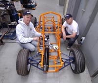 pics show Gareth and Mike with the car chassis - Gareth wearing hooded top