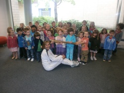 Dr Anna Campbell with the torch and the nursery children