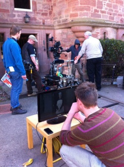 Image is of a behind-the-scenes shot on the film's set