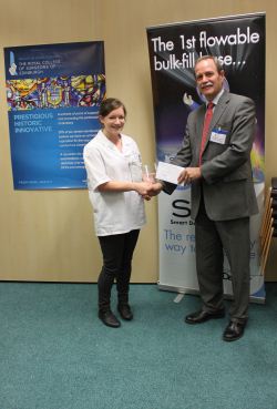 Picture shows Shona receiving her prize from competition judge Martin Donachie, a Fellow of the RCSEd.