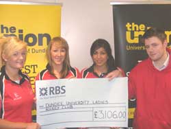 picture shows (from left to right): Imogen Manning (Treasurer), Kylie Skelton (Club Captain) and Esha Vohra (Social Secretary) receiving a cheque from DUSA President Andrew Smith
