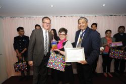 Image shows Judy receiving her award from Keith Parton of Clariant (left) and SDC President Dr Sanjiv Kamat.
